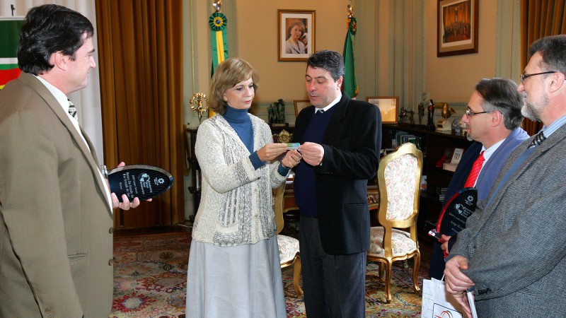 A governadora Yeda Crusius, recebe do presidente do Banrisul, Fernando Lemos , o cartão de Registro de Identidade Civil(RIC).
